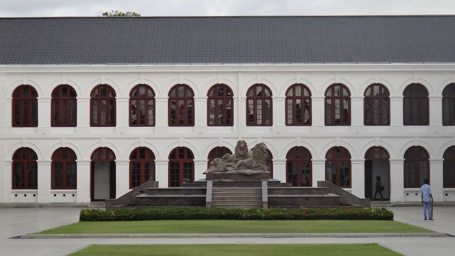 Colonial white brickwork standing as a silent ghost of the British era, best captured under high-contrast artificial lights