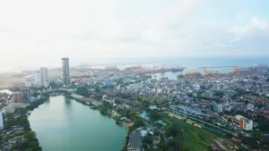 A wide-angle survey from the 29th floor, where the Beira Lake’s ancient curves meet the industrial rhythm of the harbor